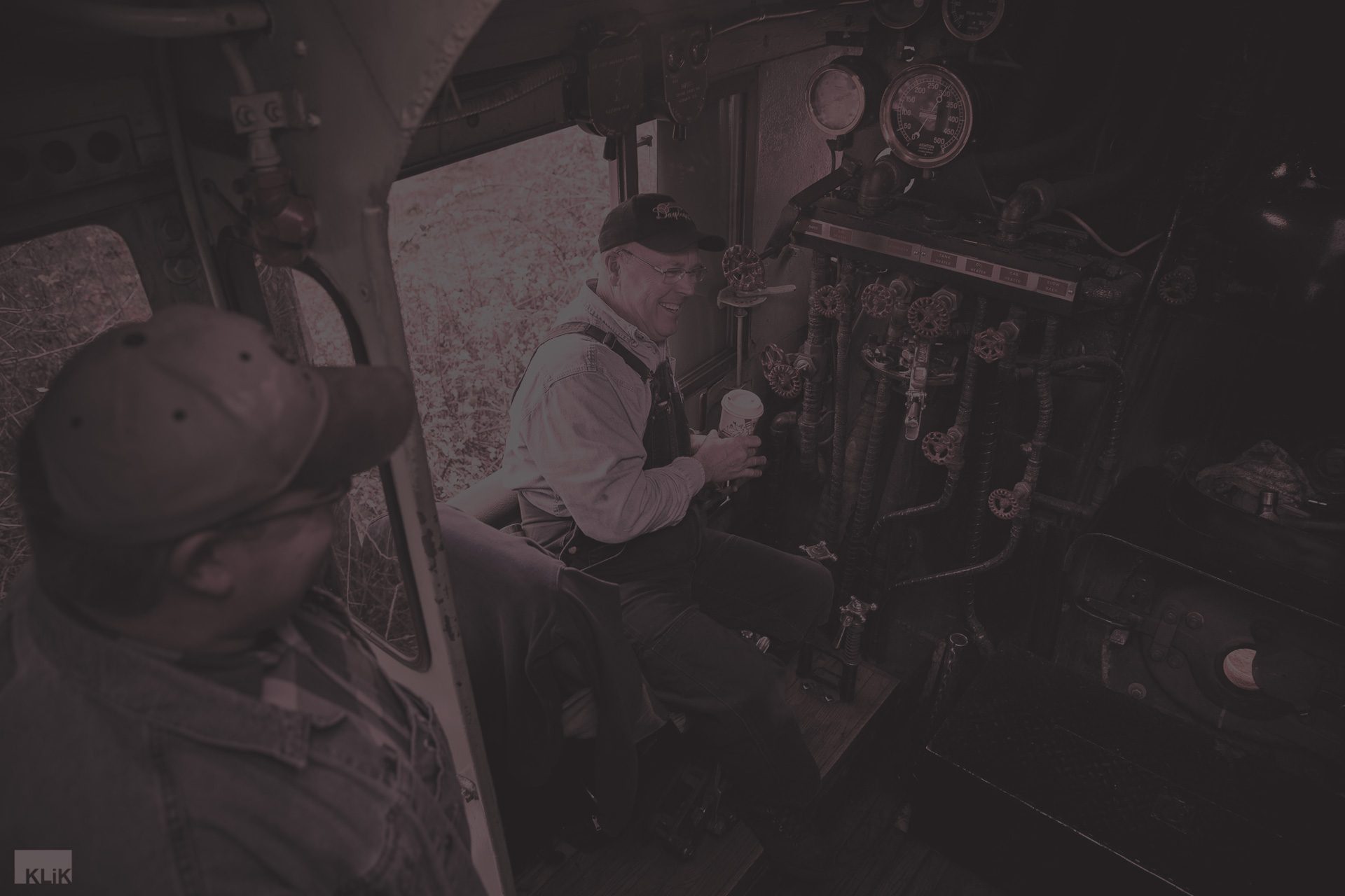 Conductor operating an antique locomotive - maroon overlay